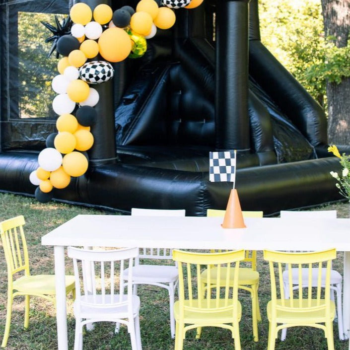Backyard kids birthday party in Dallas with a modern bounce house and kids tables